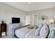 Cozy bedroom featuring a bed with stylish pillows, a dresser, and an open doorway at 5120 Woodhurst Ln, Indianapolis, IN 46239