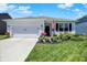 Charming single-story home featuring a manicured lawn and inviting curb appeal with lush floral landscaping at 5120 Woodhurst Ln, Indianapolis, IN 46239