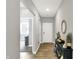 Inviting hallway with hardwood floors, neutral paint, and decorative console table adding a touch of elegance at 5120 Woodhurst Ln, Indianapolis, IN 46239