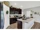 Well-designed kitchen with dark wood cabinetry, a center island and modern appliances creating a functional workspace at 5120 Woodhurst Ln, Indianapolis, IN 46239