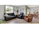 Inviting living room featuring leather furniture, neutral walls, and a large window at 5120 Woodhurst Ln, Indianapolis, IN 46239