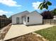 Backyard featuring a large concrete patio, perfect for outdoor entertaining, and mature trees at 5210 Sandy Forge Dr, Indianapolis, IN 46221