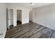 Spacious bedroom with wood-look floors, with multiple closets and bathroom access at 5210 Sandy Forge Dr, Indianapolis, IN 46221