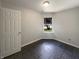 Cozy bedroom with neutral walls, tiled floors, and natural light streaming through the window, creating a serene space at 5210 Sandy Forge Dr, Indianapolis, IN 46221