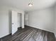 Inviting bedroom with wood-look flooring, a closet, neutral paint, and a ceiling light enhancing the cozy ambiance at 5210 Sandy Forge Dr, Indianapolis, IN 46221