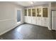 Dining area with tiled floors, built-in cabinetry, and a door leading to the outdoors, filled with sunlight at 5210 Sandy Forge Dr, Indianapolis, IN 46221