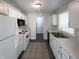 Clean kitchen featuring white cabinets, modern appliances, and neutral walls and flooring at 5210 Sandy Forge Dr, Indianapolis, IN 46221