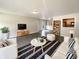Bright living room with sleek tile floors, built-in shelving, and neutral decor at 5210 Sandy Forge Dr, Indianapolis, IN 46221