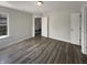Bright living room featuring modern wood-look floors, neutral paint, and ample natural light through the window at 5210 Sandy Forge Dr, Indianapolis, IN 46221
