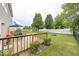 This backyard features a wood deck, a lawn, a firepit, and a fence for privacy at 5504 Grassy Bank Dr, Indianapolis, IN 46237