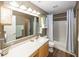 Bathroom featuring vinyl floors, a large vanity, and a tub-shower combo at 5504 Grassy Bank Dr, Indianapolis, IN 46237