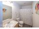 This bright bathroom features a single sink vanity and a shower with a polka-dot shower curtain at 5504 Grassy Bank Dr, Indianapolis, IN 46237