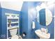 Cozy half bathroom featuring blue painted walls, decorative wall decor, and a toilet at 5504 Grassy Bank Dr, Indianapolis, IN 46237