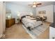 Comfortable bedroom featuring neutral carpet, a ceiling fan, and a plush bed at 5504 Grassy Bank Dr, Indianapolis, IN 46237