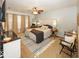 Comfortable bedroom featuring neutral carpet, a ceiling fan, and a plush bed at 5504 Grassy Bank Dr, Indianapolis, IN 46237