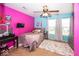 This vibrant bedroom features a ceiling fan and a window allowing for ample natural light at 5504 Grassy Bank Dr, Indianapolis, IN 46237
