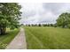 Enjoy community green space with a walking path for outdoor recreation and relaxation at 5504 Grassy Bank Dr, Indianapolis, IN 46237