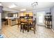 Well-lit kitchen with light wood cabinetry, neutral countertops, and an open layout to dining area at 5504 Grassy Bank Dr, Indianapolis, IN 46237