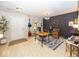 Bright living area with laminate flooring, a black accent wall, and stylish furnishings at 5504 Grassy Bank Dr, Indianapolis, IN 46237