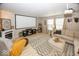 Cozy living room with a fireplace, projector screen, and comfortable furnishings, perfect for relaxing at 5504 Grassy Bank Dr, Indianapolis, IN 46237