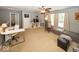 Spacious living room with neutral carpet, a ceiling fan, and abundant natural light at 5504 Grassy Bank Dr, Indianapolis, IN 46237