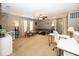 Spacious living area with neutral carpet, a ceiling fan, and abundant natural light at 5504 Grassy Bank Dr, Indianapolis, IN 46237