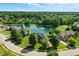 Beautiful aerial view of a neighborhood featuring a serene pond at 5761 Coopers Hawk Dr, Carmel, IN 46033