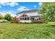Backyard with screened porch, a well-manicured lawn, and a mix of brick and white siding at 5761 Coopers Hawk Dr, Carmel, IN 46033