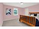 Bedroom with a wooden bed frame and light pink walls at 5761 Coopers Hawk Dr, Carmel, IN 46033