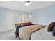 Bedroom with a wooden bed frame, gray carpet, and multiple access doors at 5761 Coopers Hawk Dr, Carmel, IN 46033