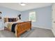 Bedroom with a wooden bed frame, window, and light blue walls at 5761 Coopers Hawk Dr, Carmel, IN 46033