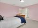 Bedroom with a wooden bed frame, and bathroom access at 5761 Coopers Hawk Dr, Carmel, IN 46033