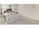 Bedroom with neutral paint, carpet, and trim, a large window, and wood door at 5761 Coopers Hawk Dr, Carmel, IN 46033