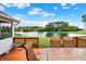 Inviting wooden deck overlooking the pond, complete with outdoor dining furniture and a view of the water fountain at 5761 Coopers Hawk Dr, Carmel, IN 46033