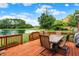 Wooden deck featuring outdoor furniture and a scenic view of the pond with a fountain at 5761 Coopers Hawk Dr, Carmel, IN 46033