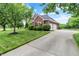 Beautiful home exterior with brick accents, a well-manicured lawn, and a paved driveway at 5761 Coopers Hawk Dr, Carmel, IN 46033