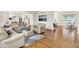 Open-concept living room with hardwood floors, comfortable seating, and easy access to the kitchen at 5761 Coopers Hawk Dr, Carmel, IN 46033