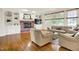Cozy living room features a brick fireplace, built-in shelving, and comfortable seating at 5761 Coopers Hawk Dr, Carmel, IN 46033
