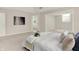 Main bedroom featuring a tray ceiling, neutral carpet, and an open bathroom concept at 5761 Coopers Hawk Dr, Carmel, IN 46033