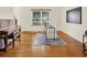 Office with hardwood floors, piano, and world map wall art at 5761 Coopers Hawk Dr, Carmel, IN 46033