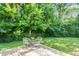 Private backyard featuring a cozy seating area and a well-manicured lawn and lush landscaping at 6491 N Oxford St, Indianapolis, IN 46220