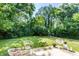 Lush backyard featuring a wooden deck and outdoor seating, perfect for relaxing and entertaining at 6491 N Oxford St, Indianapolis, IN 46220