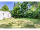 Expansive backyard features an abundance of green space, large trees, partial fence, and a deck at 6491 N Oxford St, Indianapolis, IN 46220