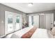 Bedroom features include hardwood floors, neutral walls, french doors, walk-in closet and a bathroom entrance at 6491 N Oxford St, Indianapolis, IN 46220