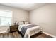 Bedroom features hardwood floors, neutral walls, and a large window for natural lighting at 6491 N Oxford St, Indianapolis, IN 46220