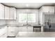 Bright kitchen featuring stainless steel appliances, white cabinets, and granite countertops at 6491 N Oxford St, Indianapolis, IN 46220