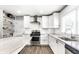Bright kitchen featuring stainless steel appliances, white cabinets, and granite countertops at 6491 N Oxford St, Indianapolis, IN 46220