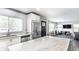 Open concept kitchen featuring white cabinets, stainless steel appliances, and a marble island at 6491 N Oxford St, Indianapolis, IN 46220