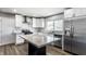 Bright kitchen featuring stainless steel appliances, white cabinets, and a marble island at 6491 N Oxford St, Indianapolis, IN 46220