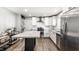 Bright kitchen featuring stainless steel appliances, white cabinets, and a marble island at 6491 N Oxford St, Indianapolis, IN 46220